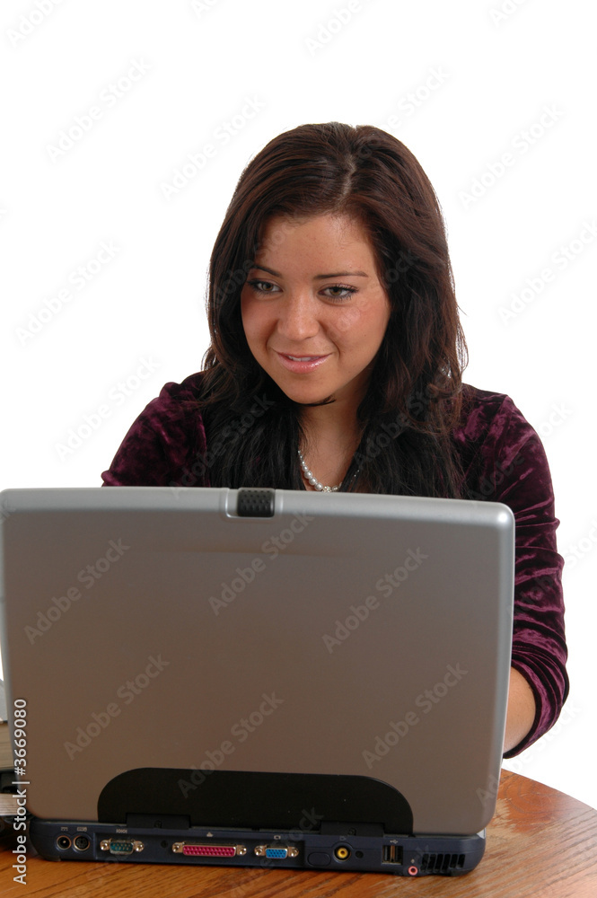 A young woman smiling while surfing the internet A young woman smiling while surfing the internet