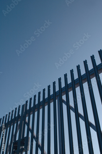 steel security gates against blue sky