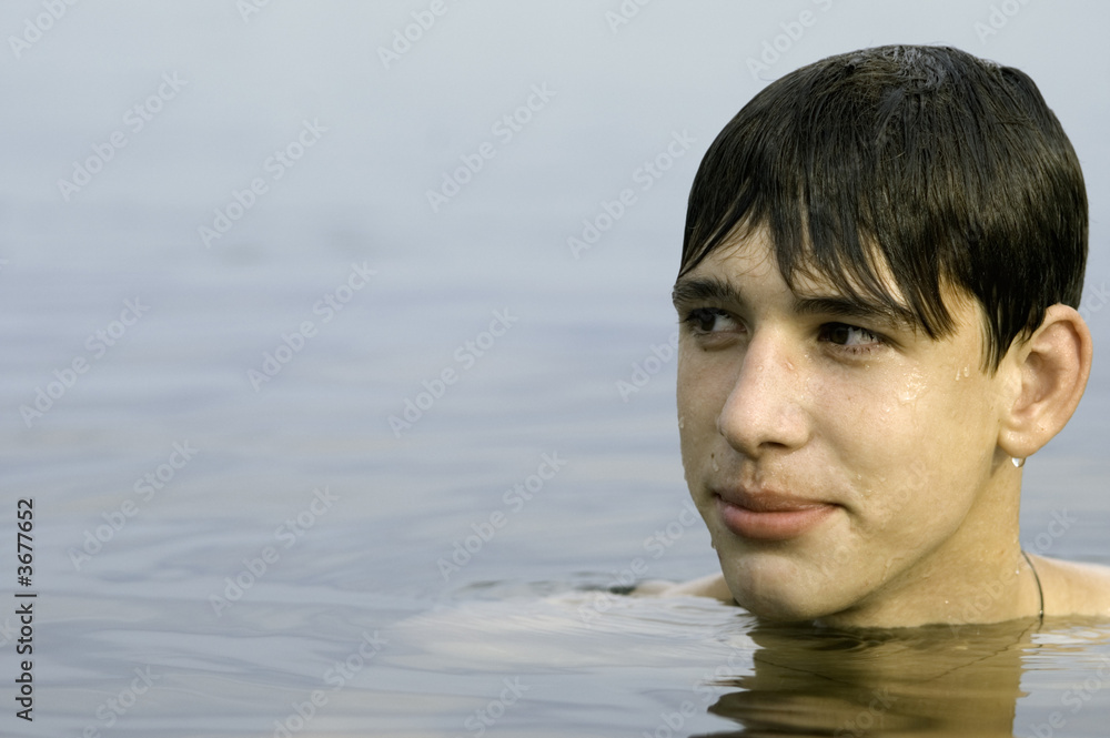 Fototapeta premium wet cute young adult in the water (focus point on eye)