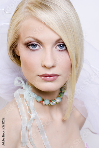 Portrait of the young blonde in a wedding veil