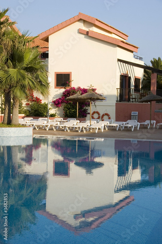 Reflection of a vacation apartment in a swimming pool.
