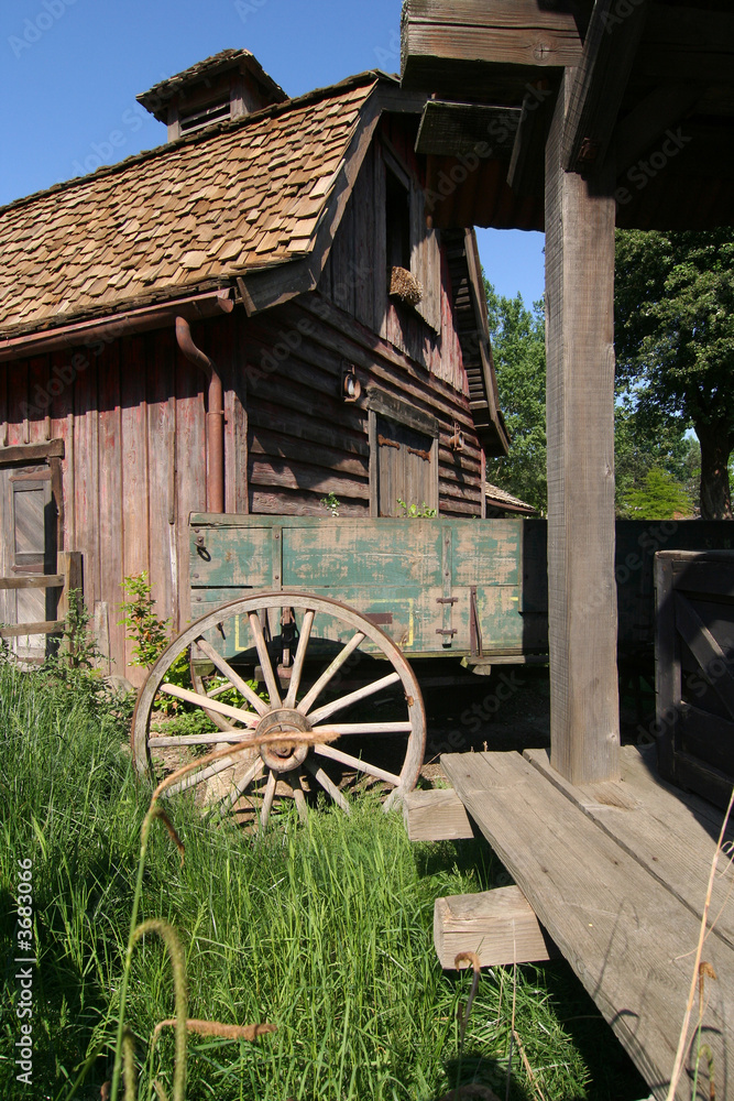 Obraz premium Cart wheel and old barn