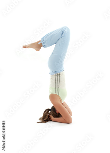 sporty girl practicing salamba sirsasana supported headstand