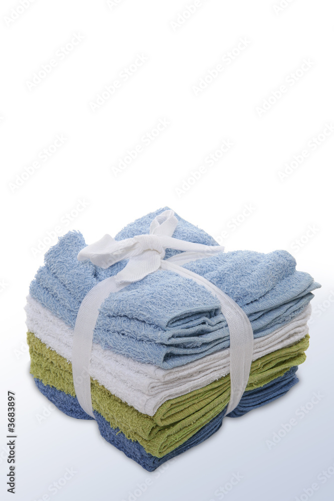 A stack of colorful face towels tied with a bow A stack of colorful face towels tied with a bow
