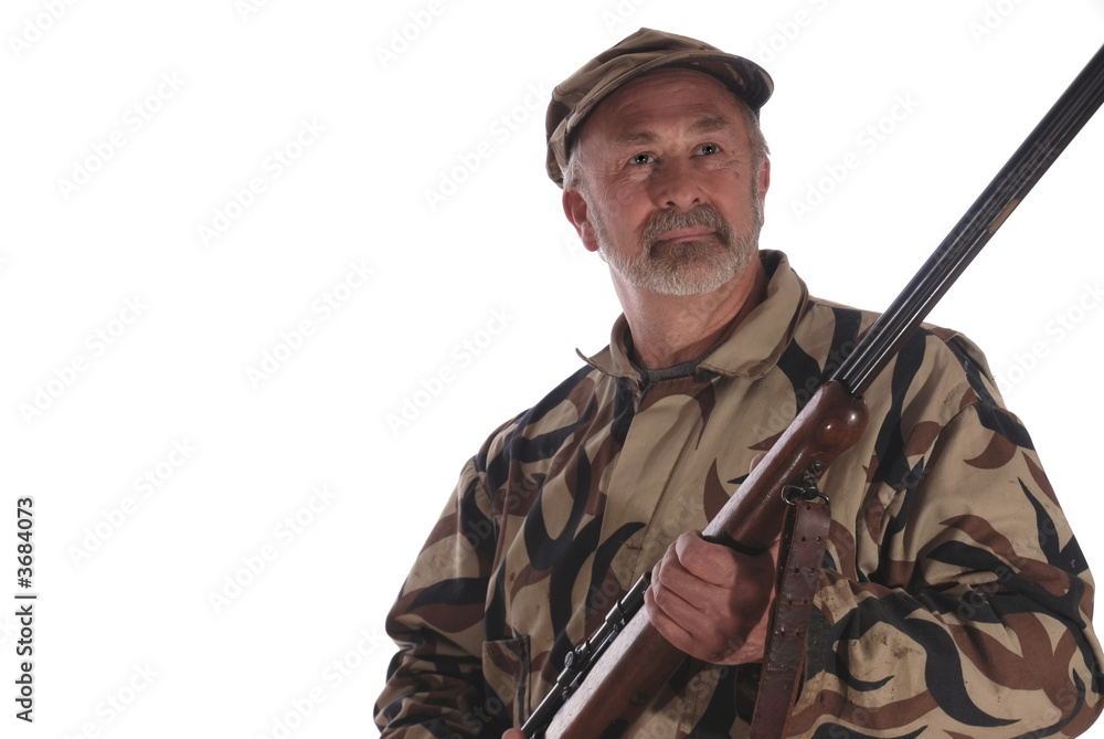 Hunter in green camouflage holding a riffle. Hunter in green camouflage holding a riffle.