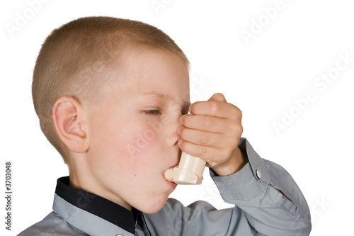 The boy injects an inhaler on an isolated background