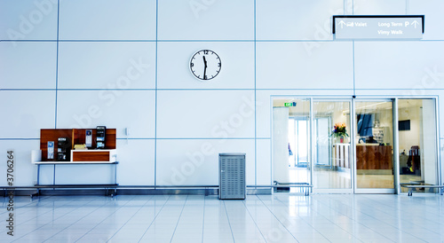 Airport Interior with clock, phones and exit