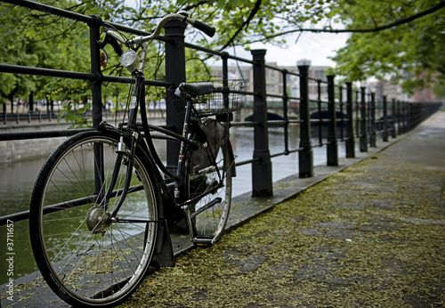 An old fashioned European bike on the banks of a river