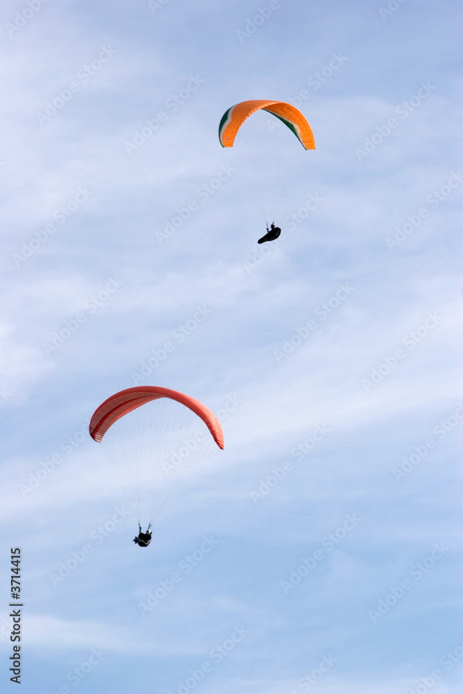 a couple of paragliders in the sky a couple of paragliders in the sky