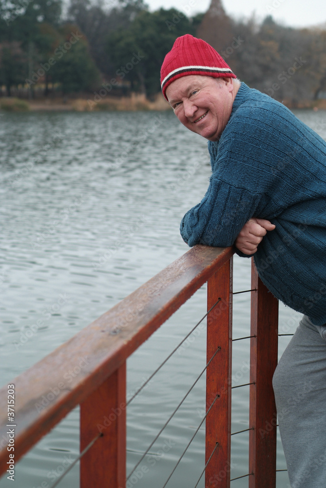 Seniors retirement image of man at side of lake or dam Seniors retirement image of man at side of lake or dam