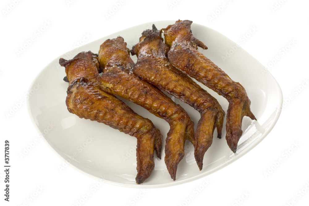 Plate of BBQ chicken wings isolated on white background.. Plate of BBQ chicken wings isolated on white background..