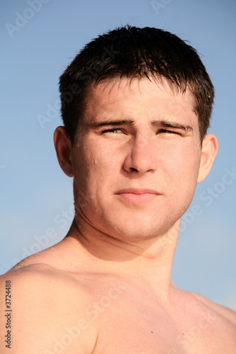 Young man on the beach against the sky