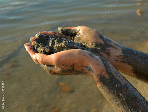 half naked woman add dead sea clay  photo