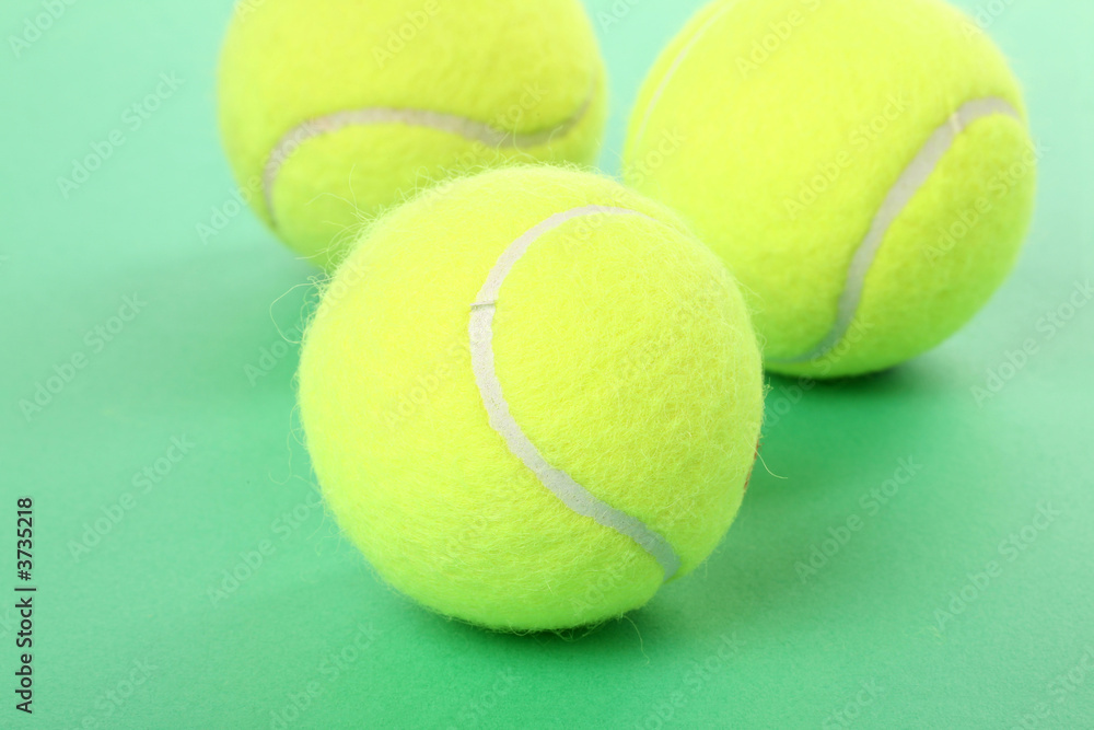 tennis balls with green background