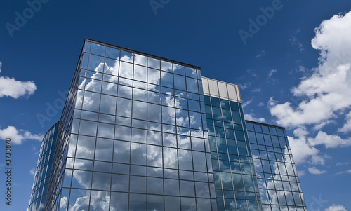 Glass building reflecting sky and clouds