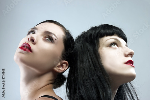 two female portraits with black hair and red lips