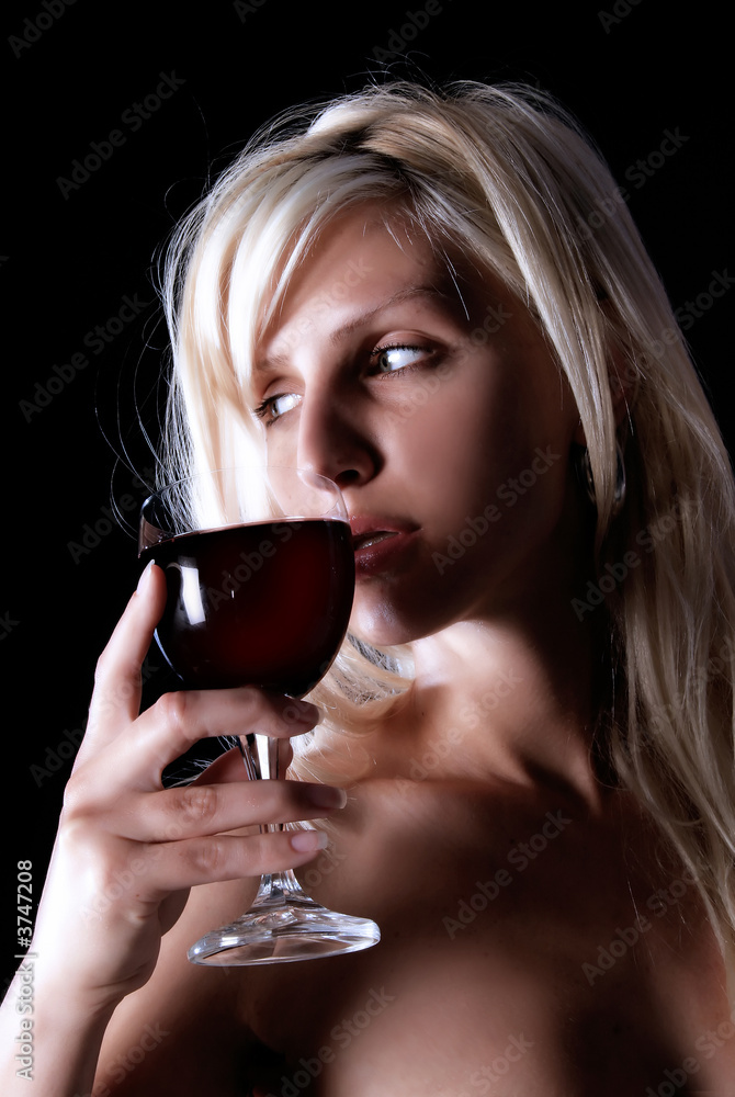 girl is standing and holding wine