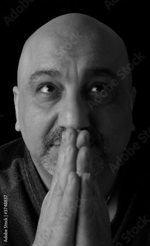 Portrait of a man praying while looking up towards heaven