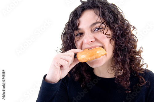 Young beautiful women eating a donut