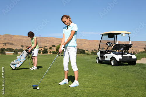 A pretty woman golfer ready to begin the golf course