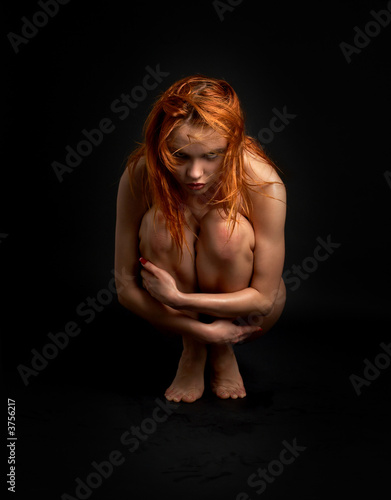 picture of offended naked redhead girl over black