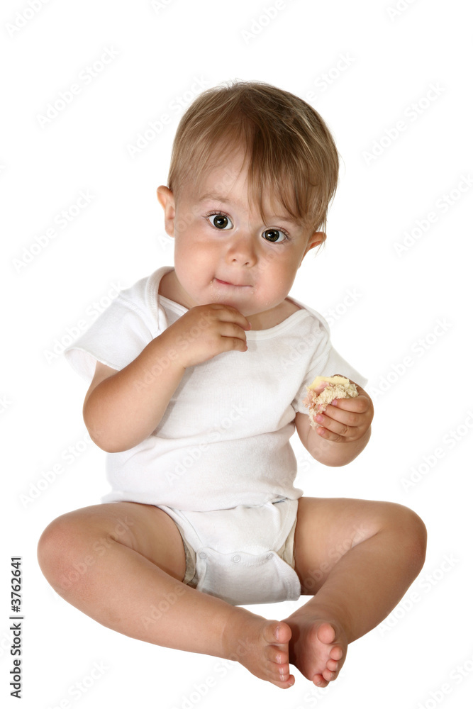 Baby boy sitting up and eating a sandwich Baby boy sitting up and eating a sandwich