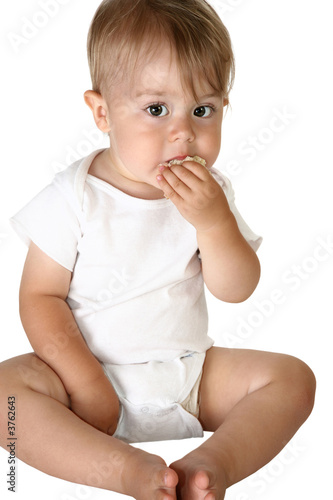 Adorable baby boy eating sandwich photo