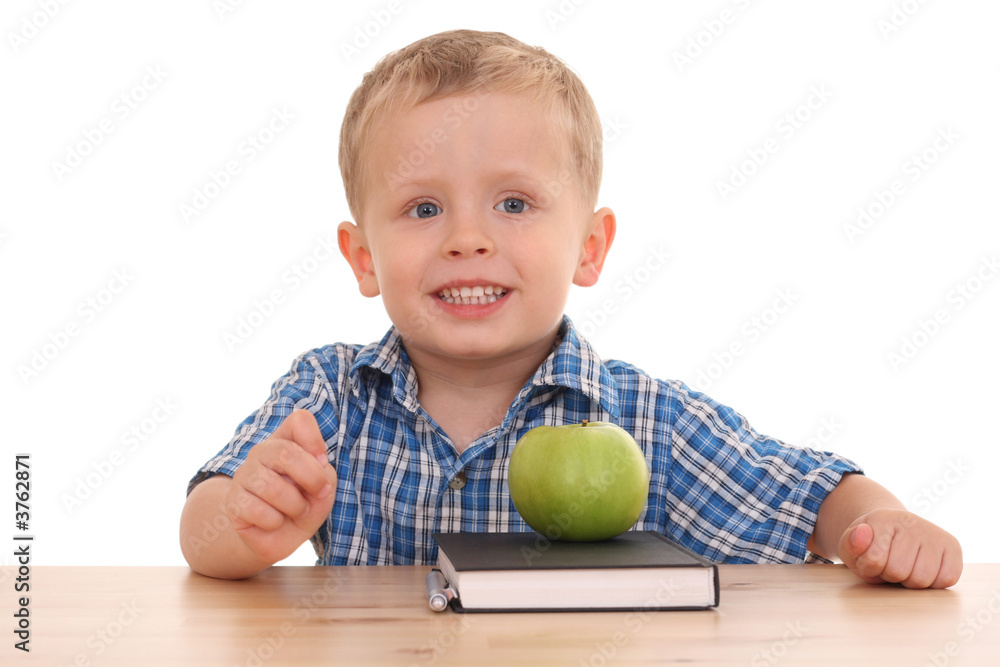 Fototapeta premium 3 years old at desk isolated on white