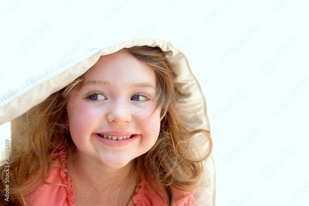 a little girl peeking out of a blanket a little girl peeking out of a blanket