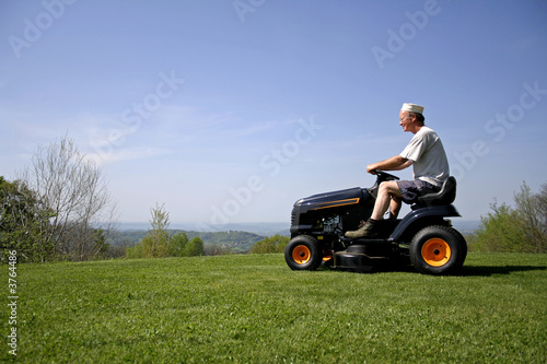man sitting on a lawnmower