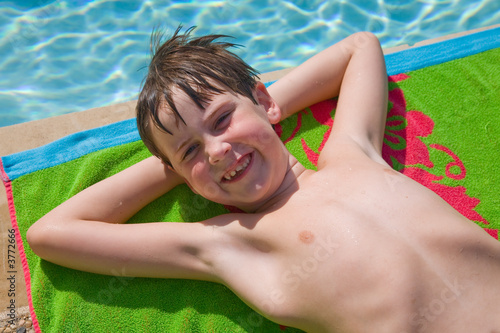 Wallpaper Mural Young boy streched out, poolside Torontodigital.ca
