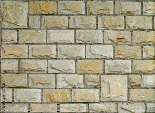 Fragment of new decorative brick wall with stucco