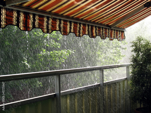 Heavy rain in the summer time under an awning