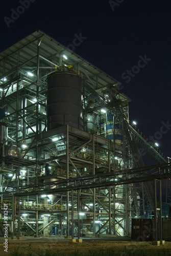 Industrial processing plant at night with lights