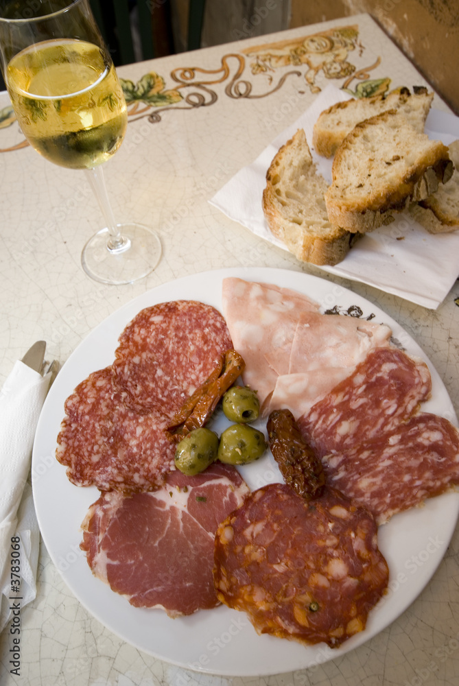 rome italy ham prosciutto salami plate with white wine rome italy ham prosciutto salami plate with white wine