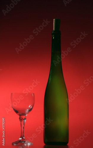 bottle of white wine on red background