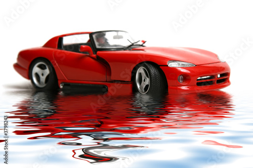 Isolated red sports car on a white background with reflex