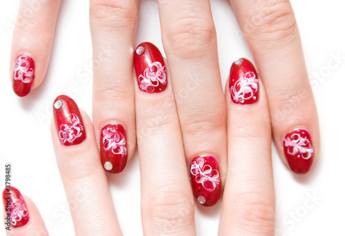 Woman fingers with decorated nails. Isolated on white.