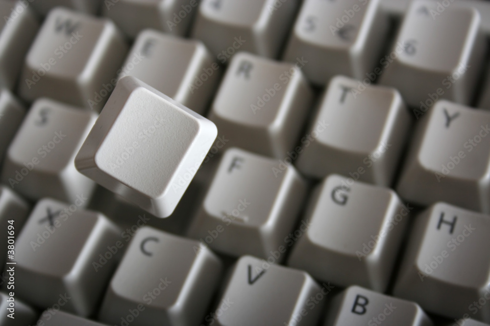 Key jumping out of keyboard with a spring. Blank key face Key jumping out of keyboard with a spring. Blank key face
