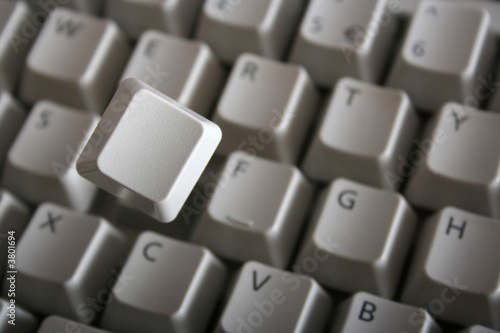 Key jumping out of keyboard with a spring. Blank key face