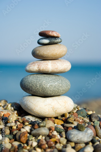 Differently sized and colored pebbles, stacked