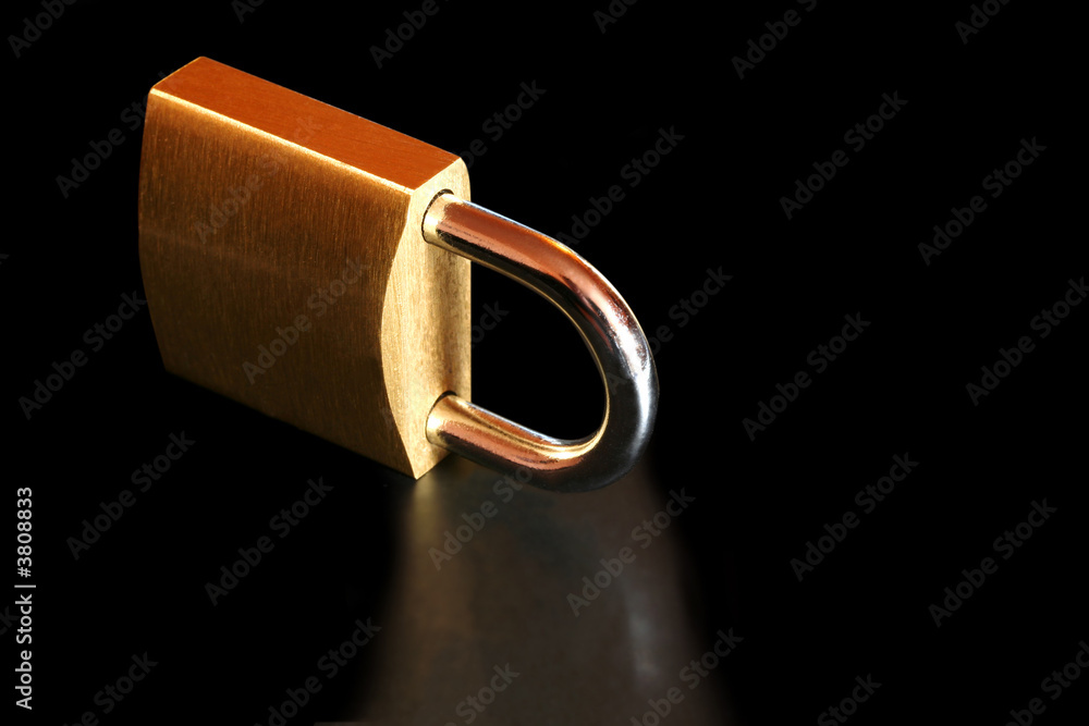 Brass Padlock, reflected on black. Brass Padlock, reflected on black.