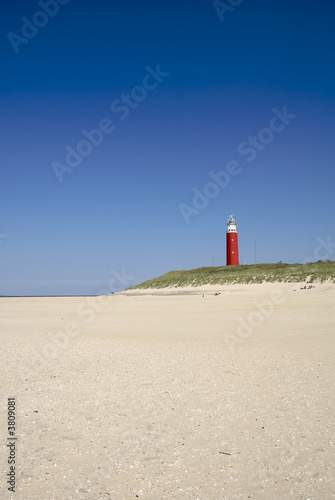 red lighthouse at the beach on texel  the netherlands 