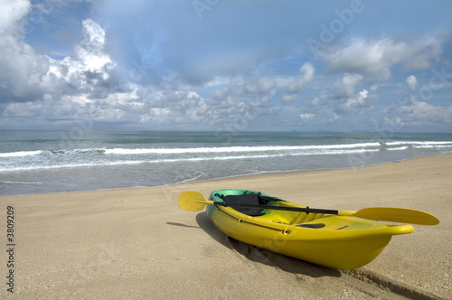 kayak on the beach with sky and Ocean