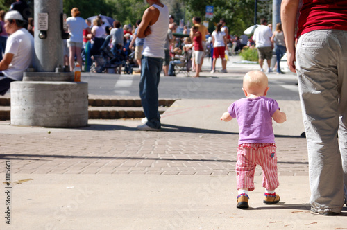 A baby enjoys a 4th of July parade with her mother.