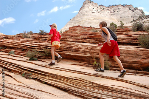 A group hikes in the red rock area of the southwest USA.