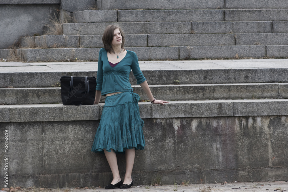 Girl with bag stands near the stairs Girl with bag stands near the stairs