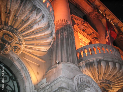 Balcony and pillars of an old building in the spotlight