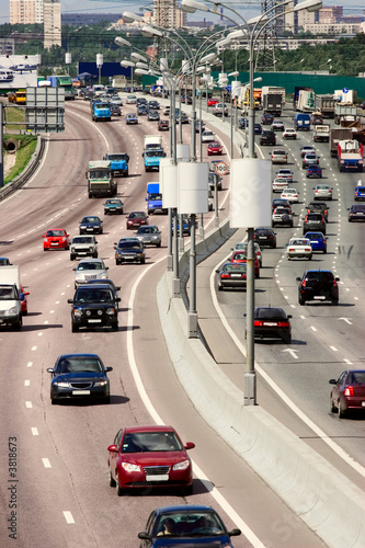 Traffic on the highway of city in a hot summer day