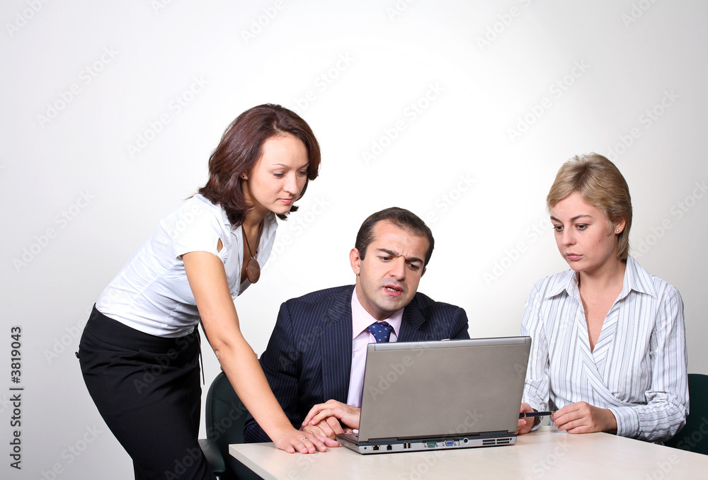 Three colleagues working at a computer. Three colleagues working at a computer.